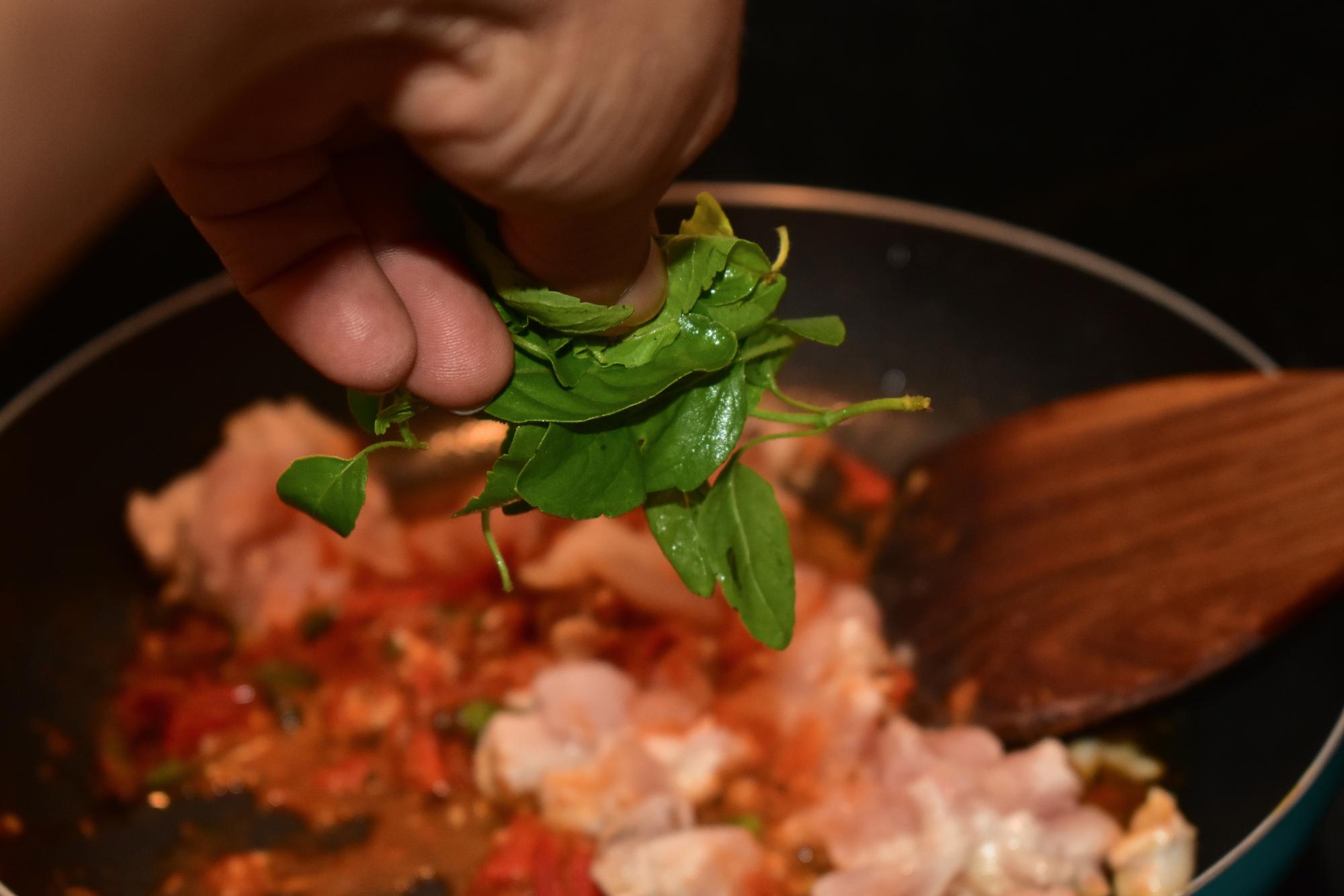 Chef hand arranging garnish on plate